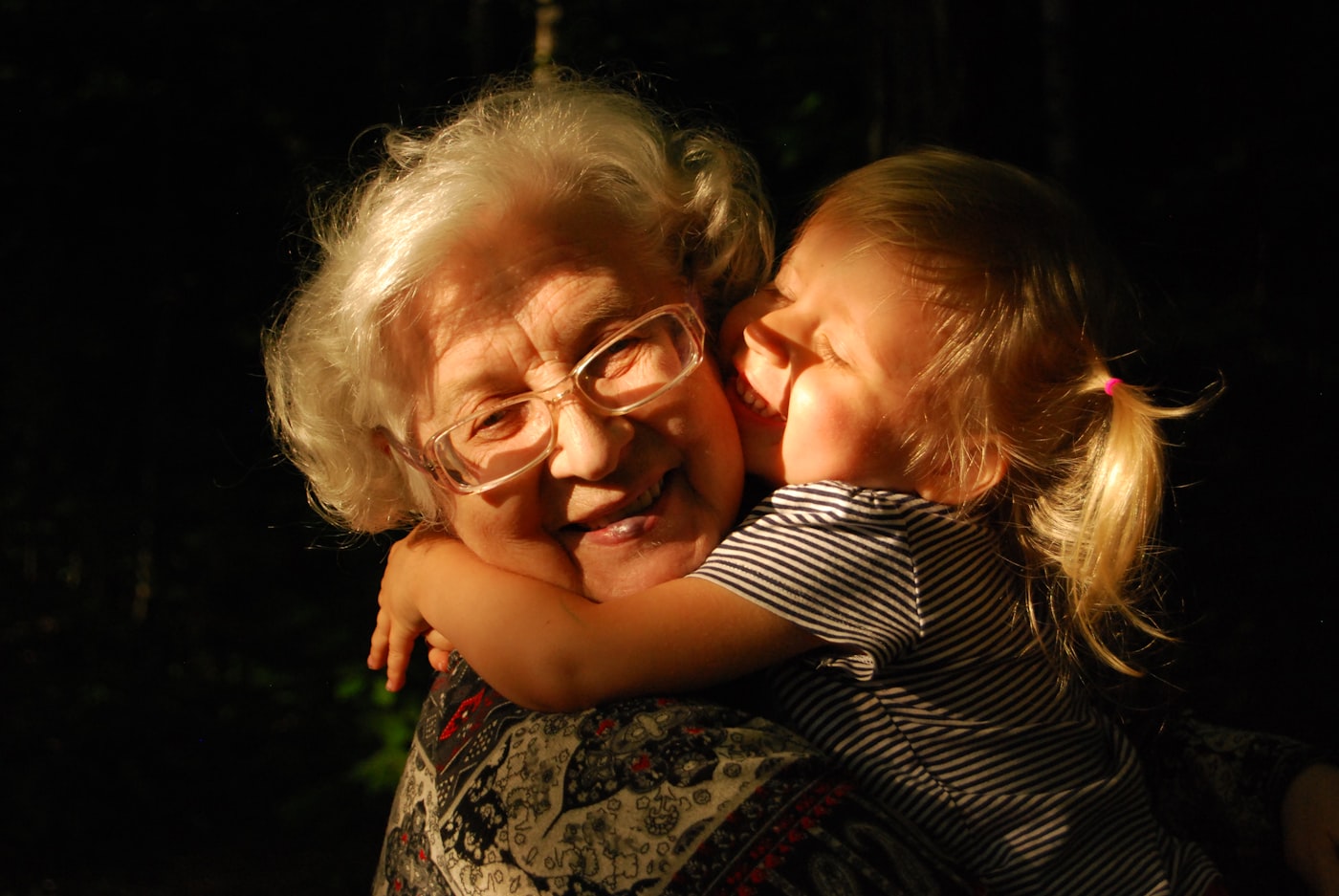 A grandmother hugging her granddaughter